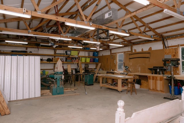 garage featuring a workshop area and visible vents