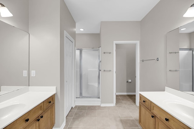 full bathroom with a stall shower, tile patterned floors, two vanities, recessed lighting, and baseboards