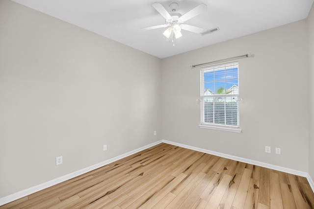 spare room with wood finished floors, baseboards, and ceiling fan