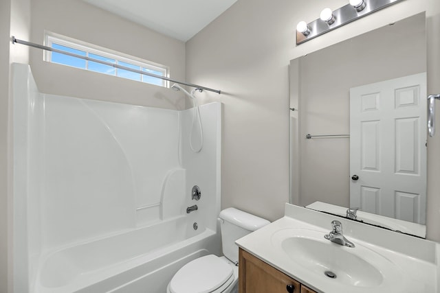 bathroom featuring toilet, vanity, and shower / tub combination