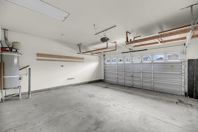 garage with secured water heater and a garage door opener