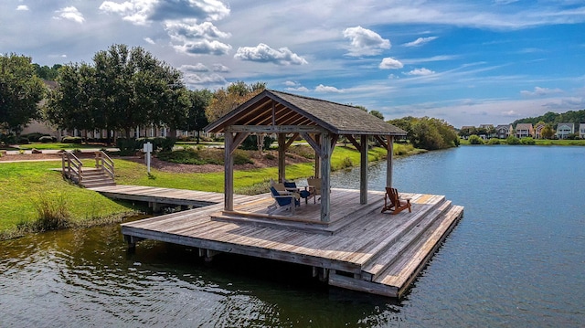 dock area featuring a gazebo, a water view, and a yard
