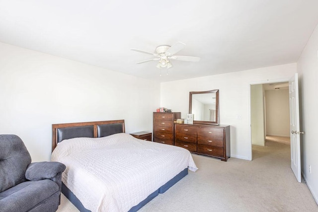 bedroom with ceiling fan, baseboards, and light colored carpet