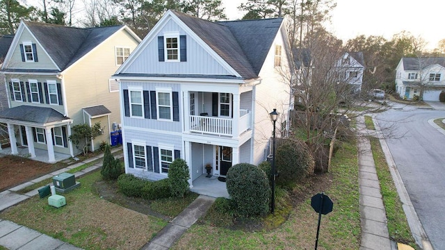 view of front of property featuring a standing seam roof, a shingled roof, and board and batten siding