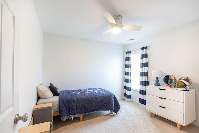 bedroom with ceiling fan, visible vents, baseboards, and light colored carpet