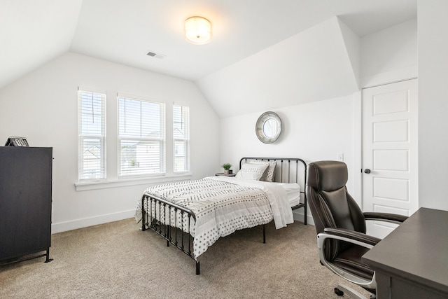 carpeted bedroom featuring multiple windows and lofted ceiling