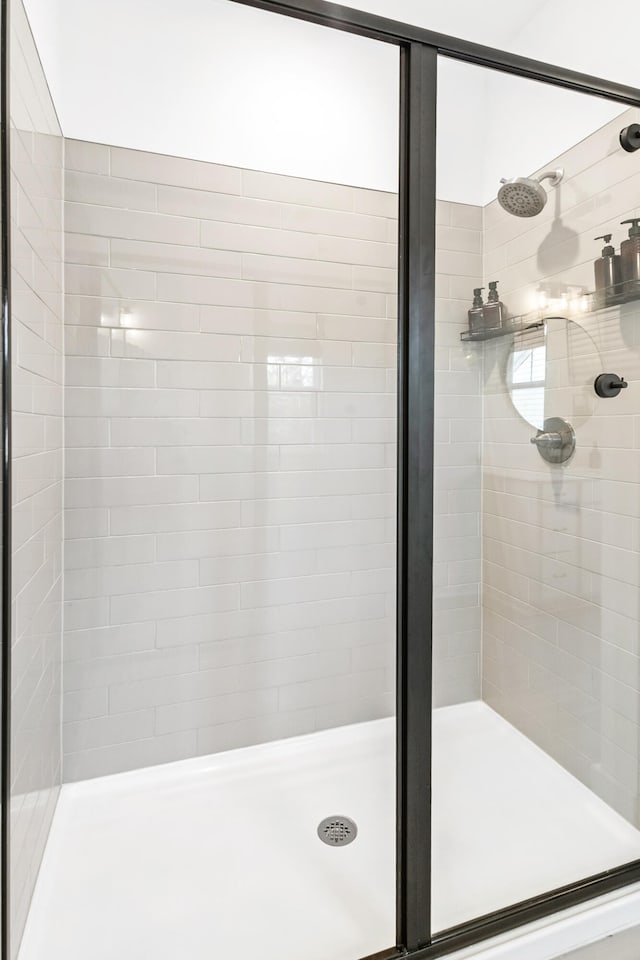 bathroom featuring a shower with shower door