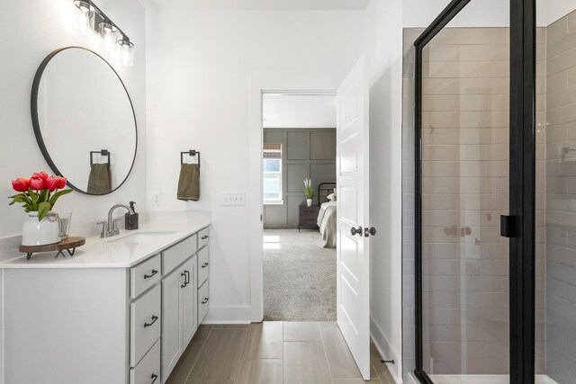 bathroom with vanity, an enclosed shower, and tile patterned flooring