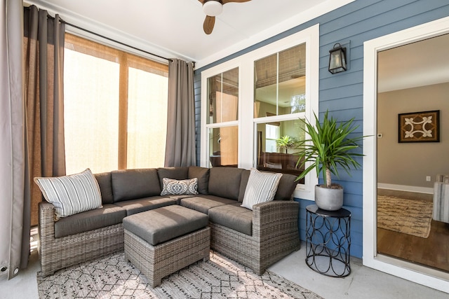 sunroom / solarium featuring ceiling fan