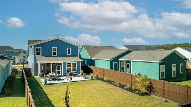 back of property featuring a patio and a lawn