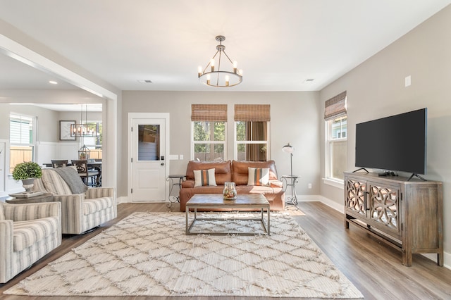 living room with a notable chandelier and hardwood / wood-style floors