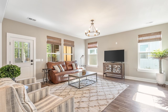 living room with an inviting chandelier and hardwood / wood-style floors