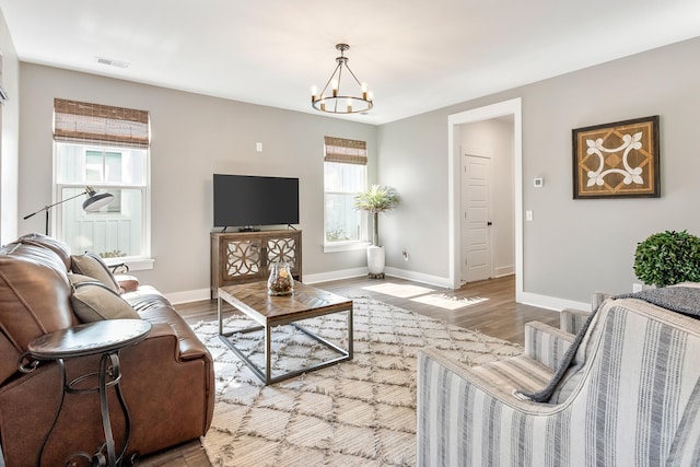 living room featuring a chandelier and hardwood / wood-style floors