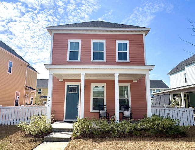 view of front of property featuring a porch and fence