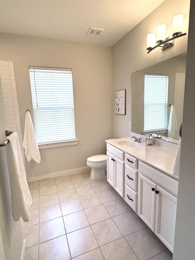 full bath with baseboards, visible vents, toilet, tile patterned floors, and vanity