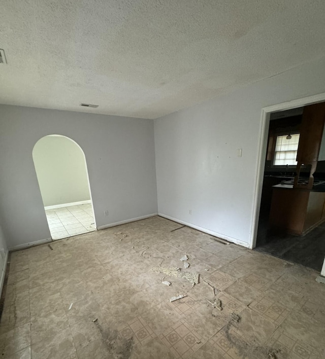 empty room featuring a textured ceiling