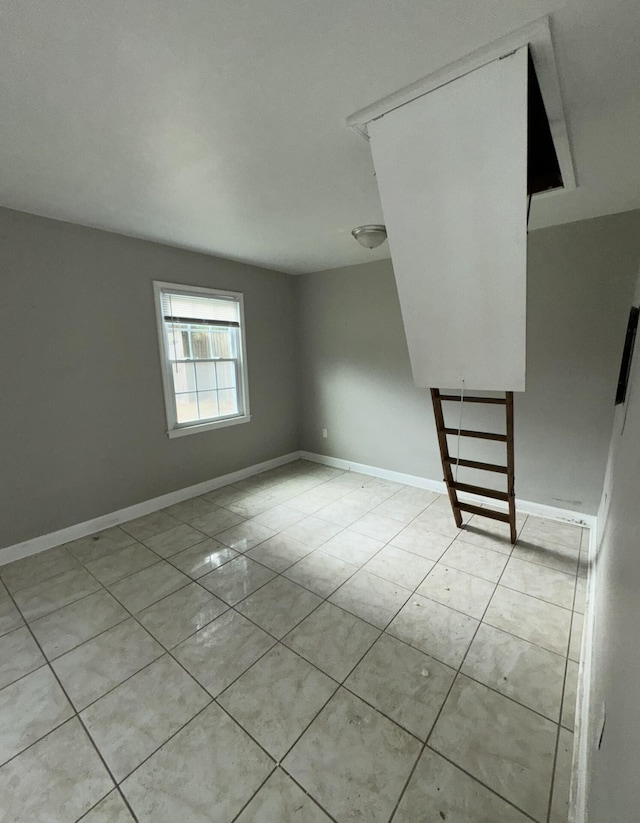 spare room featuring light tile patterned flooring