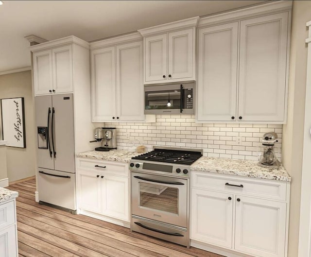 kitchen featuring white cabinets, stainless steel appliances, light hardwood / wood-style floors, and decorative backsplash