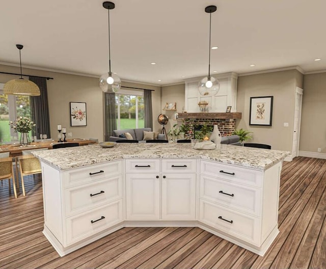 kitchen with white cabinets, light hardwood / wood-style flooring, a center island, and crown molding