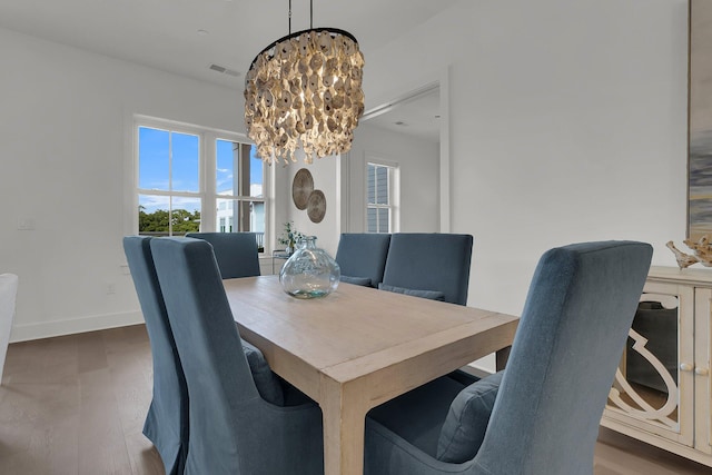 dining area featuring a chandelier and dark hardwood / wood-style floors