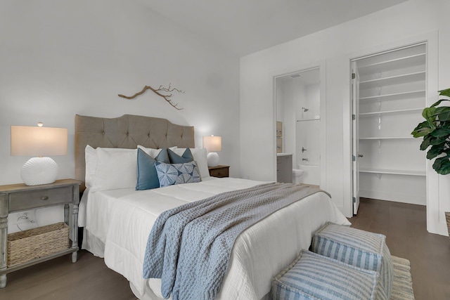 bedroom with dark hardwood / wood-style floors, a walk in closet, and ensuite bathroom