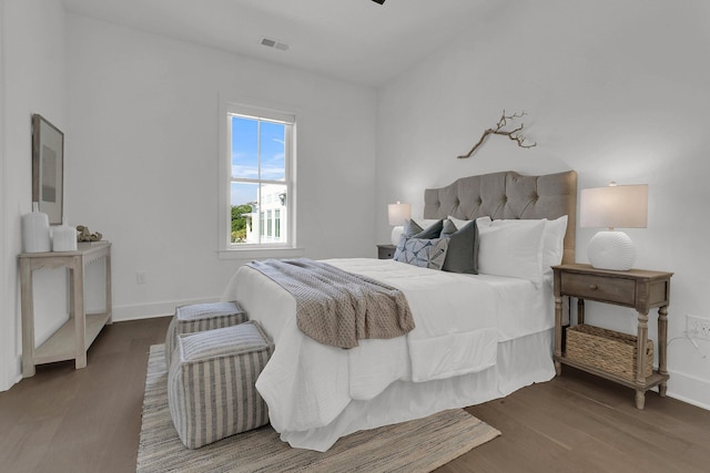 bedroom with dark hardwood / wood-style flooring