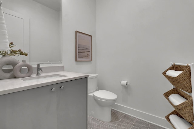 bathroom featuring vanity, toilet, and tile flooring