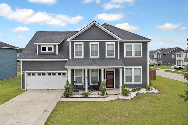 view of front facade featuring a garage, a front yard, and covered porch