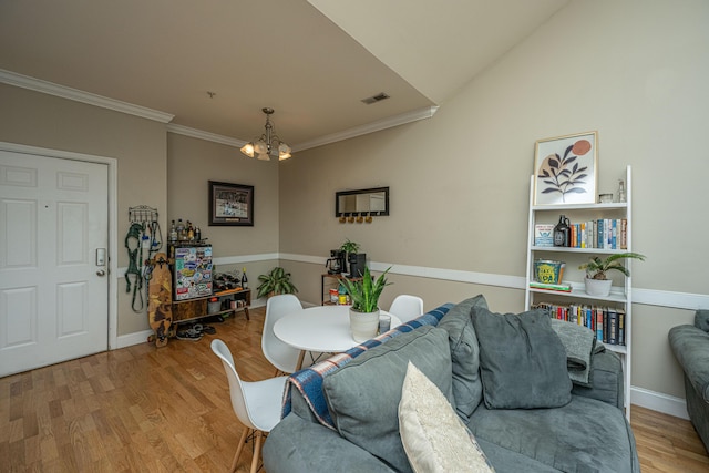 dining area featuring hardwood / wood-style floors, a notable chandelier, and ornamental molding