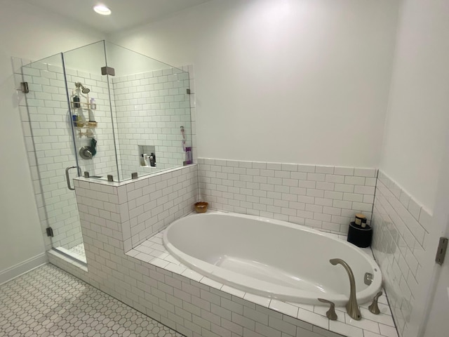 full bathroom featuring a shower stall, a bath, and tile patterned floors