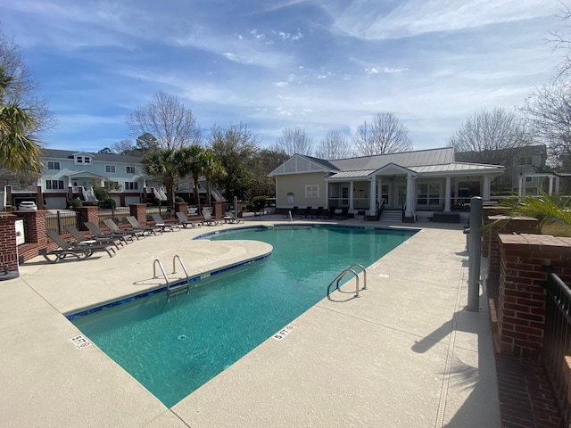 pool with fence and a patio