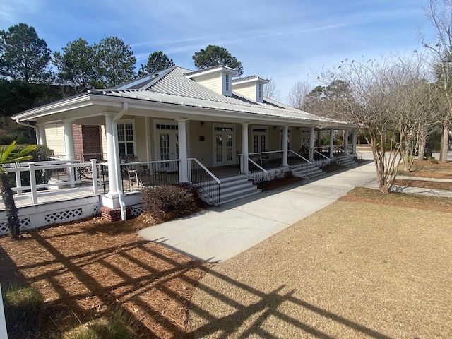 view of front of property featuring metal roof, a porch, and french doors