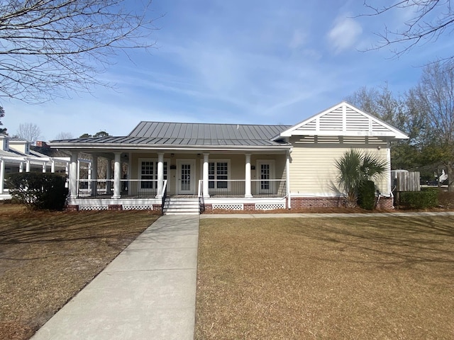 view of front of home featuring covered porch, metal roof, and a standing seam roof