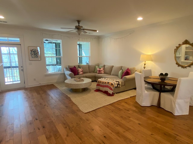 living room with crown molding, recessed lighting, wood-type flooring, and ceiling fan