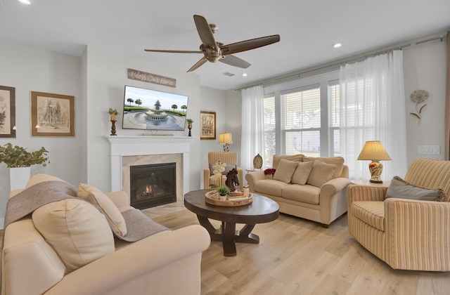 living room with ceiling fan and light hardwood / wood-style floors