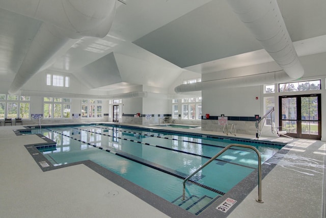 view of swimming pool with french doors