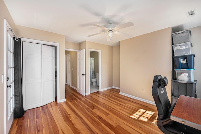 office with visible vents, light wood-style flooring, a ceiling fan, and baseboards