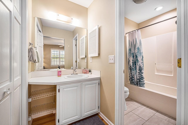 bathroom featuring vanity, baseboards, tile patterned flooring, shower / tub combo, and toilet