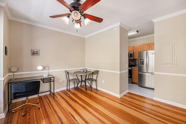 office with baseboards, a ceiling fan, light wood-style floors, and ornamental molding