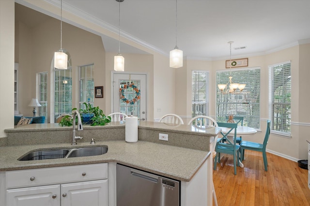 kitchen featuring dishwasher, a sink, a chandelier, light wood-style flooring, and white cabinets