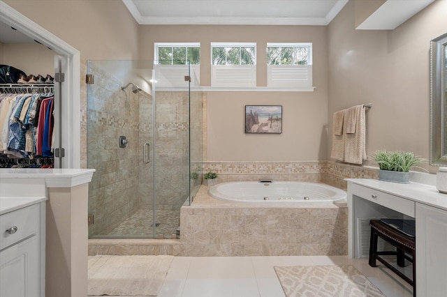 bathroom with vanity, tile patterned floors, a bath, a stall shower, and a spacious closet
