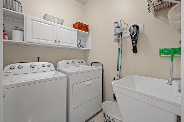 laundry area with washing machine and dryer and cabinet space