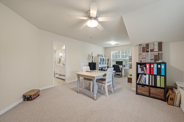office with light carpet, ceiling fan, and baseboards