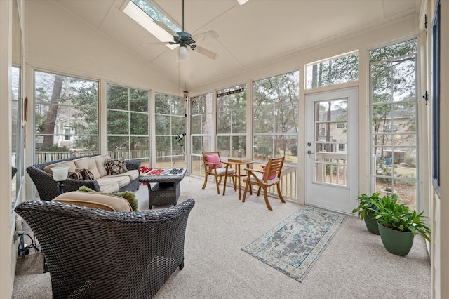 sunroom / solarium with a ceiling fan, outdoor lounge area, vaulted ceiling, and a skylight