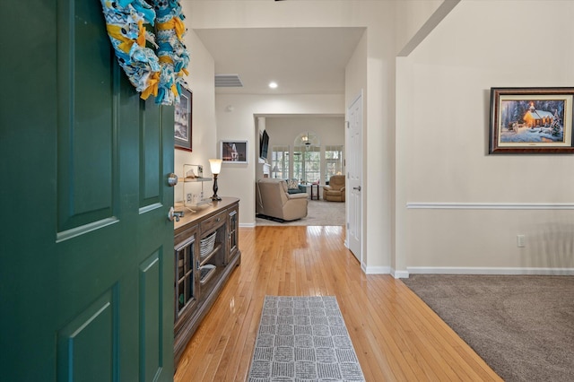 entryway with light wood-type flooring, baseboards, and recessed lighting
