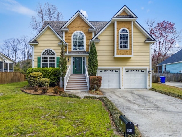 traditional-style house with an attached garage, a front lawn, fence, roof with shingles, and driveway