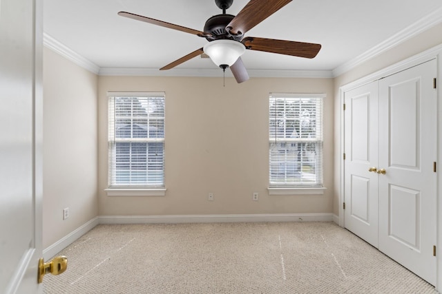 spare room featuring light carpet, plenty of natural light, and ornamental molding