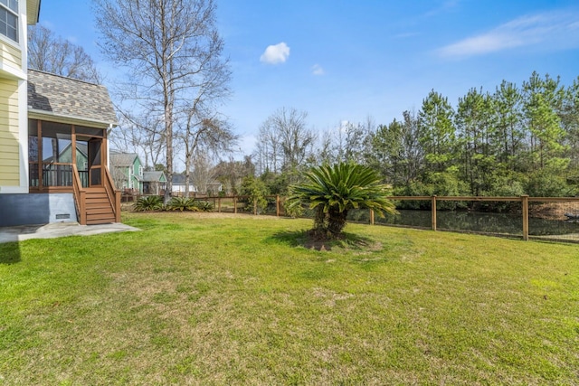 view of yard with a fenced backyard and a sunroom