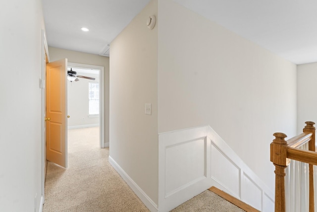 corridor featuring an upstairs landing, recessed lighting, light colored carpet, and baseboards