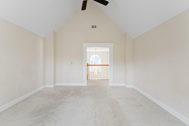 unfurnished room with visible vents, baseboards, light colored carpet, high vaulted ceiling, and a ceiling fan